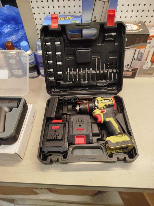 Power drill set with accessories in a case on a table